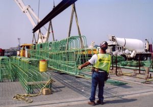 Worker Extending Length of Pier Replacement Pieces